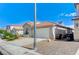 Exterior showcases a well-maintained home, two-car garage, desert landscaping, and tiled roof at 1829 Fighting Falcon Ln, North Las Vegas, NV 89031