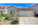 Charming single-story home features a two-car garage, desert landscaping, and a red tile roof at 1829 Fighting Falcon Ln, North Las Vegas, NV 89031