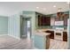Modern kitchen with dark cabinets, white appliances, breakfast bar, and wood-look tile flooring at 1829 Fighting Falcon Ln, North Las Vegas, NV 89031