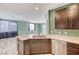 Kitchen and living area featuring stainless steel appliances and tile floors at 1829 Fighting Falcon Ln, North Las Vegas, NV 89031