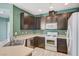 Kitchen with dark cabinets, stainless steel appliances, and tile flooring at 1829 Fighting Falcon Ln, North Las Vegas, NV 89031