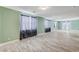 Expansive living room boasts wood-look tile, neutral walls, and abundant natural light from large windows at 1829 Fighting Falcon Ln, North Las Vegas, NV 89031