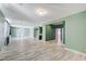 Spacious living room with wood-look tile flooring, neutral walls, and abundant natural light at 1829 Fighting Falcon Ln, North Las Vegas, NV 89031