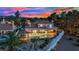 An aerial view of the home at sunset with a pool, and landscaped yard at 1984 Troon Dr, Henderson, NV 89074