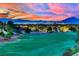 Scenic aerial view of a lush green golf course with city and mountain views in the background at 1984 Troon Dr, Henderson, NV 89074
