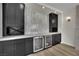 Modern bar area with dual wine coolers, sleek cabinetry, and stylish backsplash at 1984 Troon Dr, Henderson, NV 89074