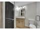 Bathroom featuring a shower, vanity, mirror, and toilet, all within a compact space at 1984 Troon Dr, Henderson, NV 89074