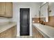 Well-lit bathroom features a single sink, stone countertops and dark fixtures at 1984 Troon Dr, Henderson, NV 89074