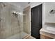 Bathroom with a glass-enclosed shower, tiled walls, and a sink vanity with a marble countertop at 1984 Troon Dr, Henderson, NV 89074