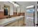 Modern bathroom featuring double sinks, wood cabinets, and tiled backsplash at 1984 Troon Dr, Henderson, NV 89074