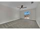 Spacious bedroom has neutral carpeting, ceiling fan, and access to a private balcony at 1984 Troon Dr, Henderson, NV 89074