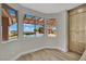 Bright dining area featuring wood floors and views of the pool and backyard at 1984 Troon Dr, Henderson, NV 89074