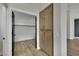 Hallway featuring wood-look floors and built-in storage cabinets, with an open closet at 1984 Troon Dr, Henderson, NV 89074