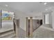 The upstairs landing features modern wood and iron railings and overlooks the living spaces at 1984 Troon Dr, Henderson, NV 89074