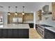 Modern kitchen with stainless steel appliances, custom cabinets, and a large center island at 1984 Troon Dr, Henderson, NV 89074