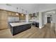 Open kitchen featuring stainless steel appliances, large island, and custom cabinets at 1984 Troon Dr, Henderson, NV 89074