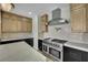 Close-up of kitchen with stainless steel appliances, custom cabinetry, and modern countertops at 1984 Troon Dr, Henderson, NV 89074