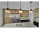 Kitchen featuring modern pendant lights, stainless steel refrigerator, and light countertops at 1984 Troon Dr, Henderson, NV 89074