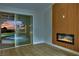 Living room with modern fireplace, wood accent wall, and sliding doors to pool/spa at 1984 Troon Dr, Henderson, NV 89074