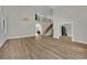 Open-concept living room with hardwood floors, staircase, and ample space for entertaining and relaxation at 1984 Troon Dr, Henderson, NV 89074