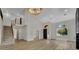 Grand living room featuring soaring ceilings, hardwood floors, and a striking staircase, filled with natural light at 1984 Troon Dr, Henderson, NV 89074