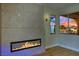Modern living room featuring a linear fireplace and bright windows with an outdoor view at 1984 Troon Dr, Henderson, NV 89074