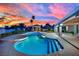 Inviting backyard pool with stepping stones, featuring a spa and gazebo, against a colorful sunset backdrop at 1984 Troon Dr, Henderson, NV 89074