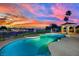 Sparkling pool with gazebo and manicured greenery, set against a vibrant sunset backdrop at 1984 Troon Dr, Henderson, NV 89074
