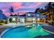 Stunning pool with a covered patio and lush landscaping, offering a perfect oasis for relaxation and entertainment at 1984 Troon Dr, Henderson, NV 89074