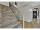 Elegant staircase with carpeted steps and black metal railings, leading to the upper level at 1984 Troon Dr, Henderson, NV 89074