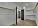 Spacious walk-in closet with built-in shelving and wood-look flooring for ample storage at 1984 Troon Dr, Henderson, NV 89074