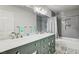 Bathroom featuring double sinks, decorative mirrors, and tile flooring at 2036 Deer Springs Dr, Henderson, NV 89074