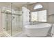 Bathroom with a freestanding tub, a modern shower, and natural light from the window at 2036 Deer Springs Dr, Henderson, NV 89074
