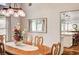 A lovely dining area featuring a wooden table with decorative centerpiece and views into the kitchen at 2036 Deer Springs Dr, Henderson, NV 89074