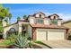 Inviting two-story home featuring a two-car garage and lush desert landscaping at 2036 Deer Springs Dr, Henderson, NV 89074
