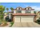Charming two-story home with a well-manicured lawn and a spacious two-car garage at 2036 Deer Springs Dr, Henderson, NV 89074