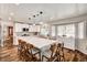 The bright open concept kitchen has white cabinets and a large island with barstool seating at 2036 Deer Springs Dr, Henderson, NV 89074