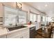Bright kitchen features a stainless sink and appliances, granite counters and a breakfast bar with a view to the backyard at 2036 Deer Springs Dr, Henderson, NV 89074