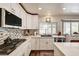 Bright and modern kitchen with white cabinets and tiled backsplash at 2036 Deer Springs Dr, Henderson, NV 89074