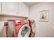 Modern laundry room with a red washer and dryer at 2036 Deer Springs Dr, Henderson, NV 89074