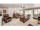A bright living room with wood floors, large windows, and views into the kitchen at 2036 Deer Springs Dr, Henderson, NV 89074
