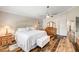Main bedroom showcasing wood flooring, a dresser, and view to the ensuite bath at 2036 Deer Springs Dr, Henderson, NV 89074