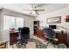 This home office provides ample space for two desks and features built in bookshelves and a ceiling fan at 2036 Deer Springs Dr, Henderson, NV 89074