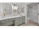 Elegant bathroom featuring a vanity, vessel sink, decorative mirrors, and a walk-in shower at 2216 Spring Water Dr, Las Vegas, NV 89134