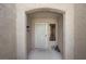 Inviting entryway with an arched opening, security door, and sidelight window with neutral decor at 2216 Spring Water Dr, Las Vegas, NV 89134