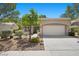 Charming single-story home with a two-car garage, well-manicured landscaping, and a spacious driveway at 2216 Spring Water Dr, Las Vegas, NV 89134