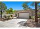 Charming single-story home with a two-car garage, well-manicured landscaping, and a spacious driveway at 2216 Spring Water Dr, Las Vegas, NV 89134