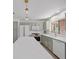 Bright kitchen boasts modern appliances, custom cabinets, large island, and stylish pendant lighting at 2216 Spring Water Dr, Las Vegas, NV 89134