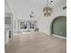 Bright living room featuring wood-look floors, high ceilings, modern lighting, and abundant natural light at 2216 Spring Water Dr, Las Vegas, NV 89134
