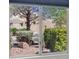 Window view of backyard landscaping, desert plants, and a neighboring property at 2216 Spring Water Dr, Las Vegas, NV 89134